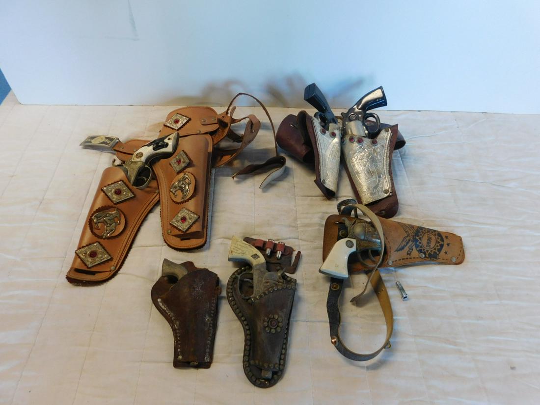 Lot of Vintage Toy Pistols with Holsters: Lot of Vintage Toy Pistols with Holsters including: two Roy Rogers (RR), leather belt and holsters, two tin toy pistols, Young Buffalo Bill toy pistol and holster, three plastic bullets, Sheriff holst
