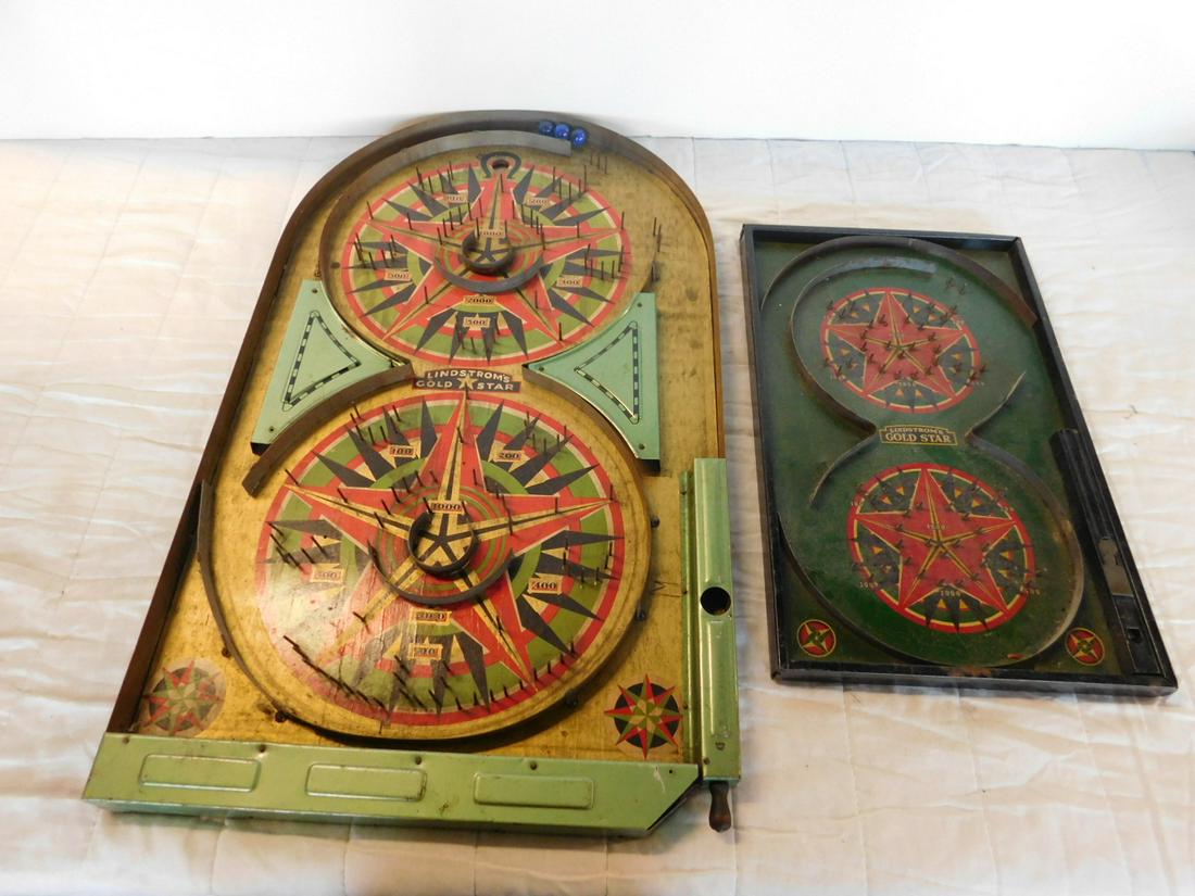 2 Vintage Lindstrom's Gold Star Pinball Machines: Two Vintage Lindstrom's Gold Star Pinball Machines, table top, faces painted with metal frames, one 9 5/8" x 15 3/8" (no shooter balls) and one 14" x 24 12' with rounded top, three replacement marbles