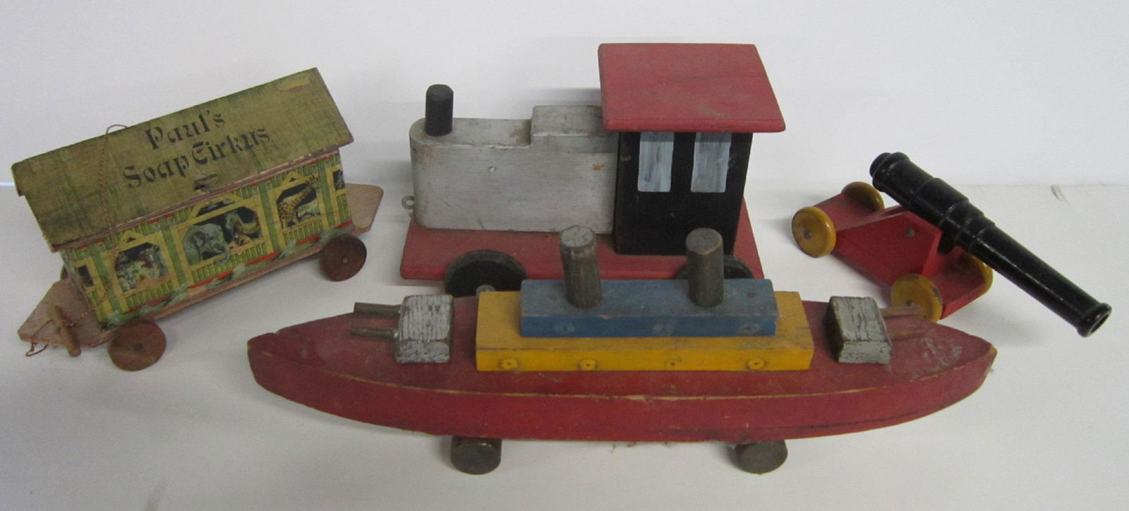 4 Vintage Wood Pull Toys: 4 Vintage Wood Pull Toys including: train engine form, 10 1/2" l x 6 1/2" h, Paul's soap circus, hinged lid roof with four animal soap figures inside,11" l., battleship with turrets front and back, 17