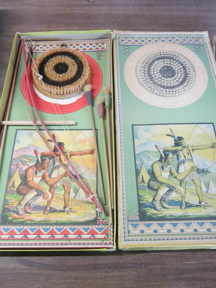 Vintage Toy Archery Set: Vintage Toy Archery Set, Indian motif, in original box including: two bows,three bristle end arrows and bristle target, 6" (detached) from hanging decorative Indian and child cardboard background 10 1