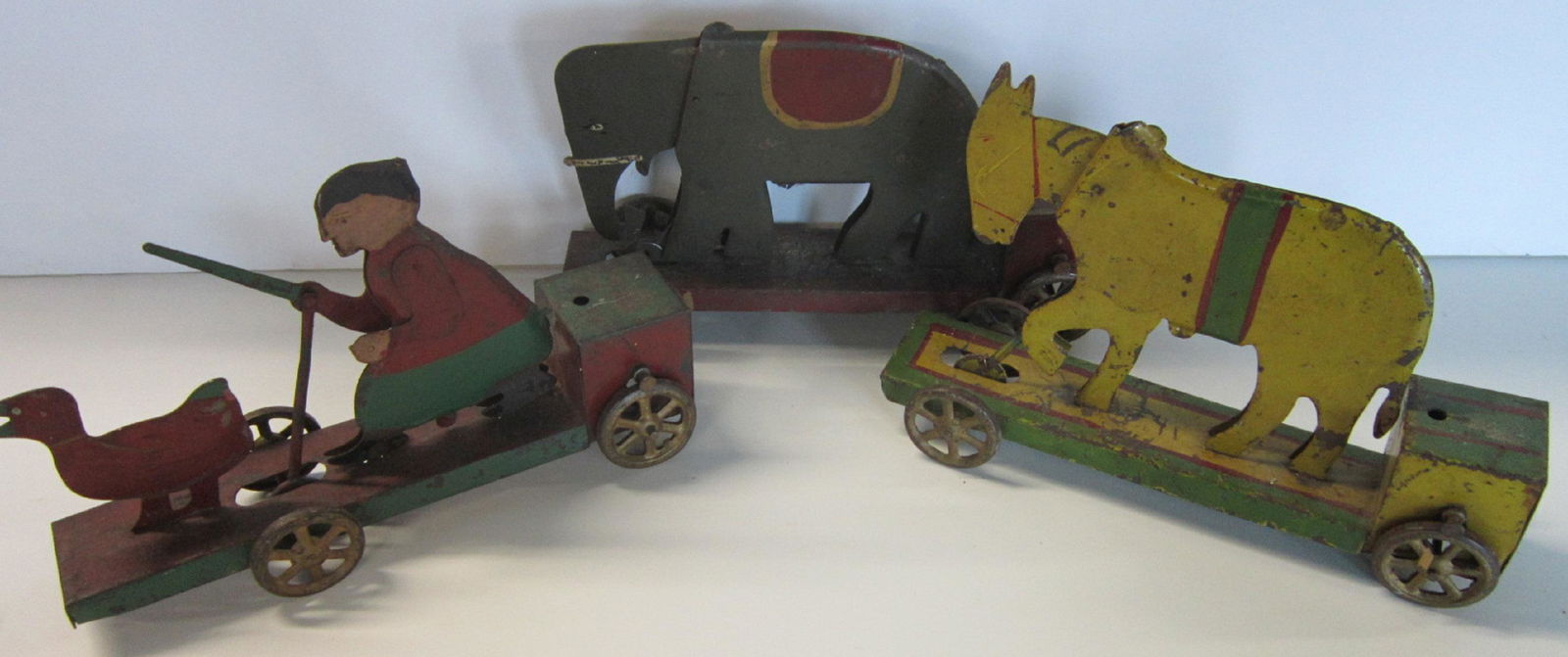 Vintage 3 Pc Circus Train: Vintage three Piece Circus Train, all hand painted with moveable figure, lady with stick and duck (stick moves up and down), elephant (bobbing head and donkey (bobbing head) all with four iron spoke w