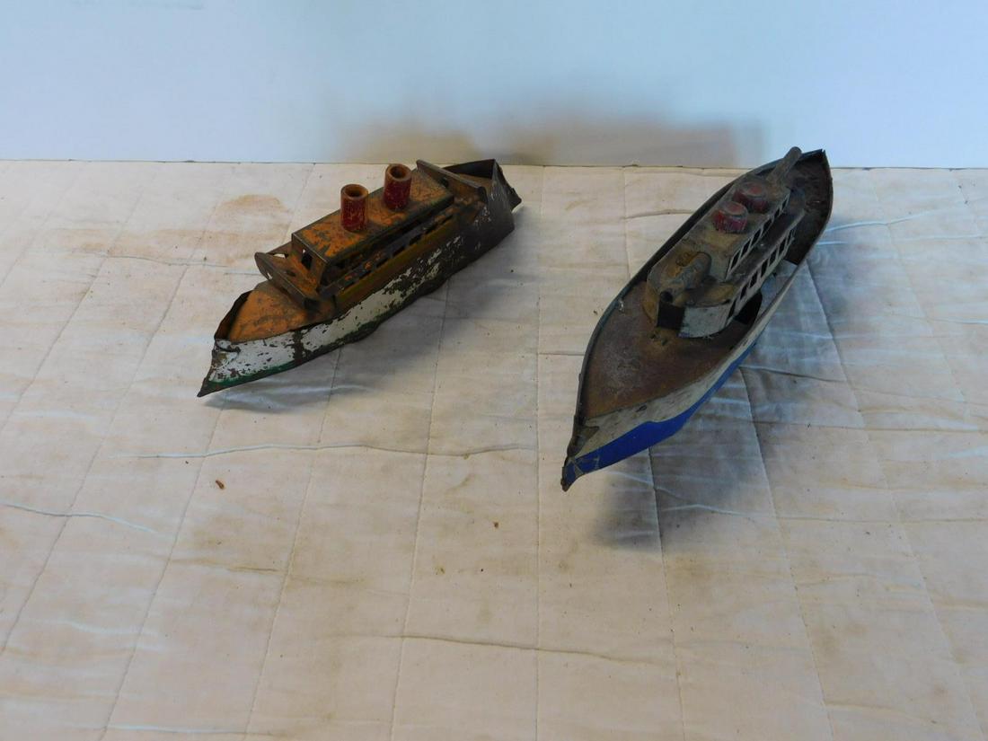 2 Antique Pressed Tin Battleships: Two Antique Pressed Tin Battleships both tin litho including: one larger, front and back top turrets (missing bottom front and back turrets), two center wheels underneath, single front and back wheels