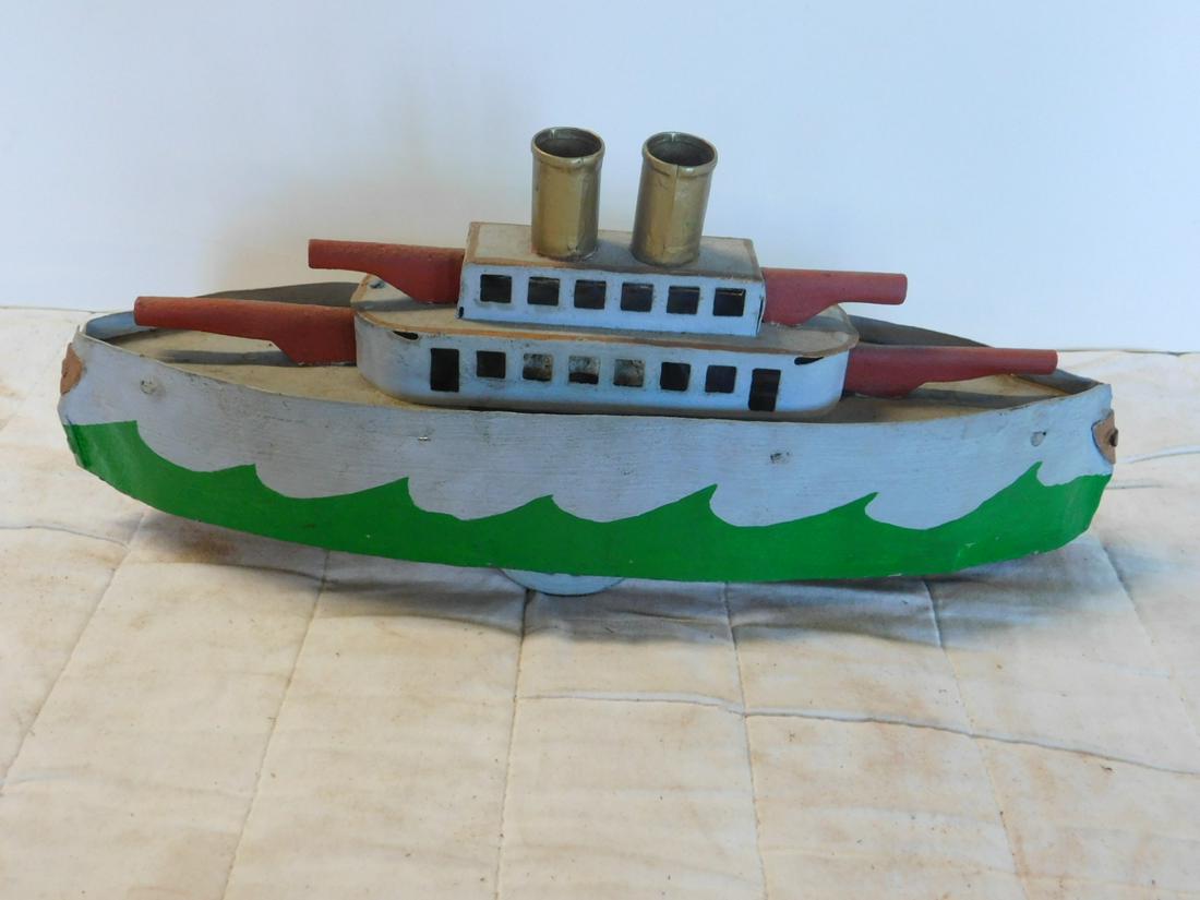 Antique Pressed Tin Battleship: Antique Pressed Tin Battleship,gun turrets front and back, two stacks (one over tin knob, other slotted), two center wheels underneath, front and back single wheel, 15"l, circa 1910 Schieble ? CONDITI