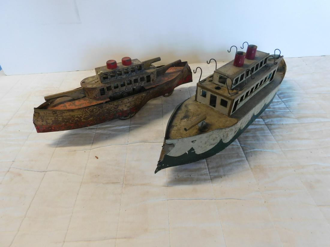 2 Antique Pressed Tin Battleships: Two Antique Pressed Tin Battleships, both missing some parts, tin litho,double stack including: smaller with front and rear gun turrets (missing one top turret), two center wheels underneath with sing