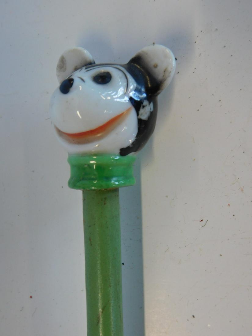 Child's Mickey Head Carnival Cane: Child's Mickey Head Carnival Cane, porcelain hand painted Mickey Mouse cane head, 2" with painted wood shaft and metal ferrule tip, 28". CONDITION: Minor paint wear to shaft.