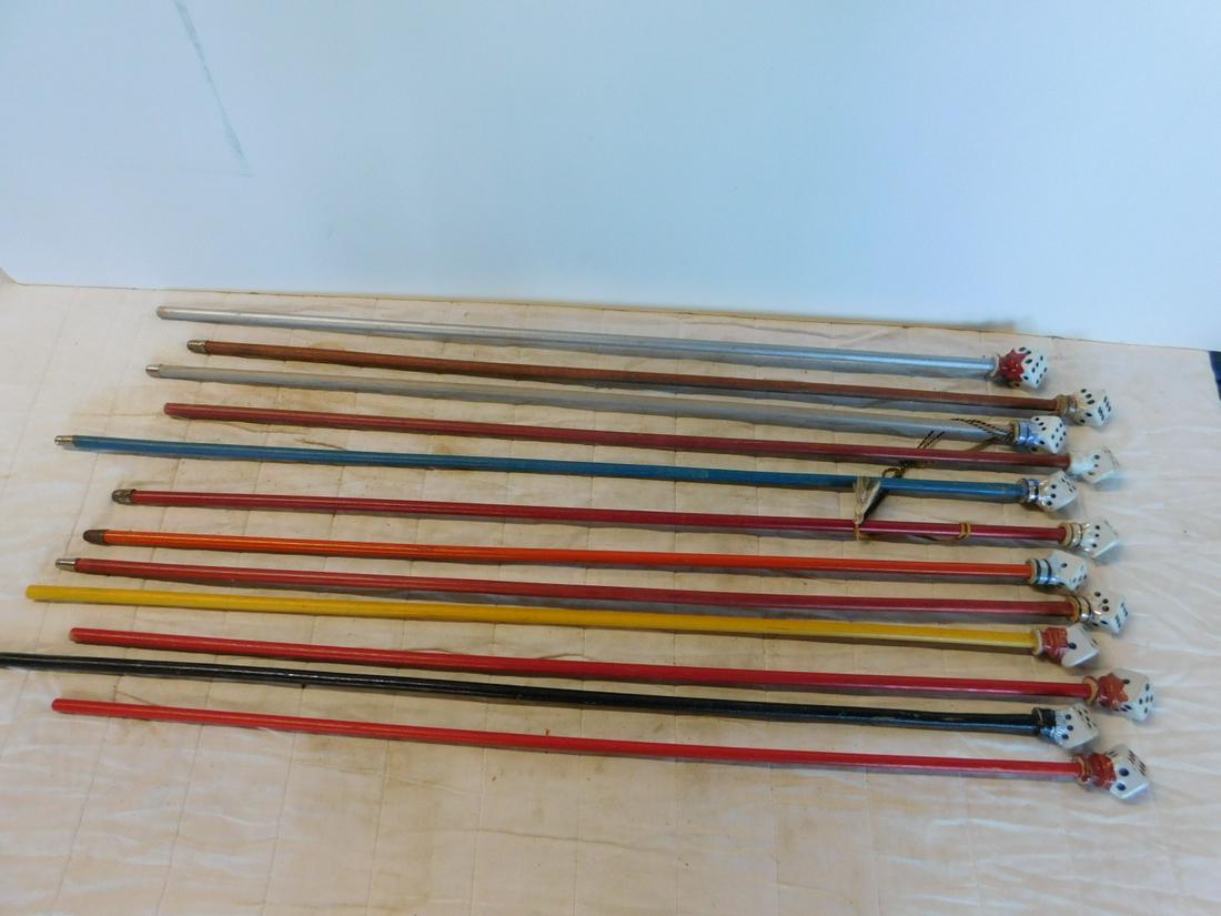 12 Vintage Porcelain Carnival Canes: Twelve Vintage Porcelain Carnival Canes, all with porcelain dice form handles, 1 1/2" wide x 2" high, all on wood shafts, six with ferrule ends, 35" - 35 1/2". CONDITION: Minor if any wear on cane hea
