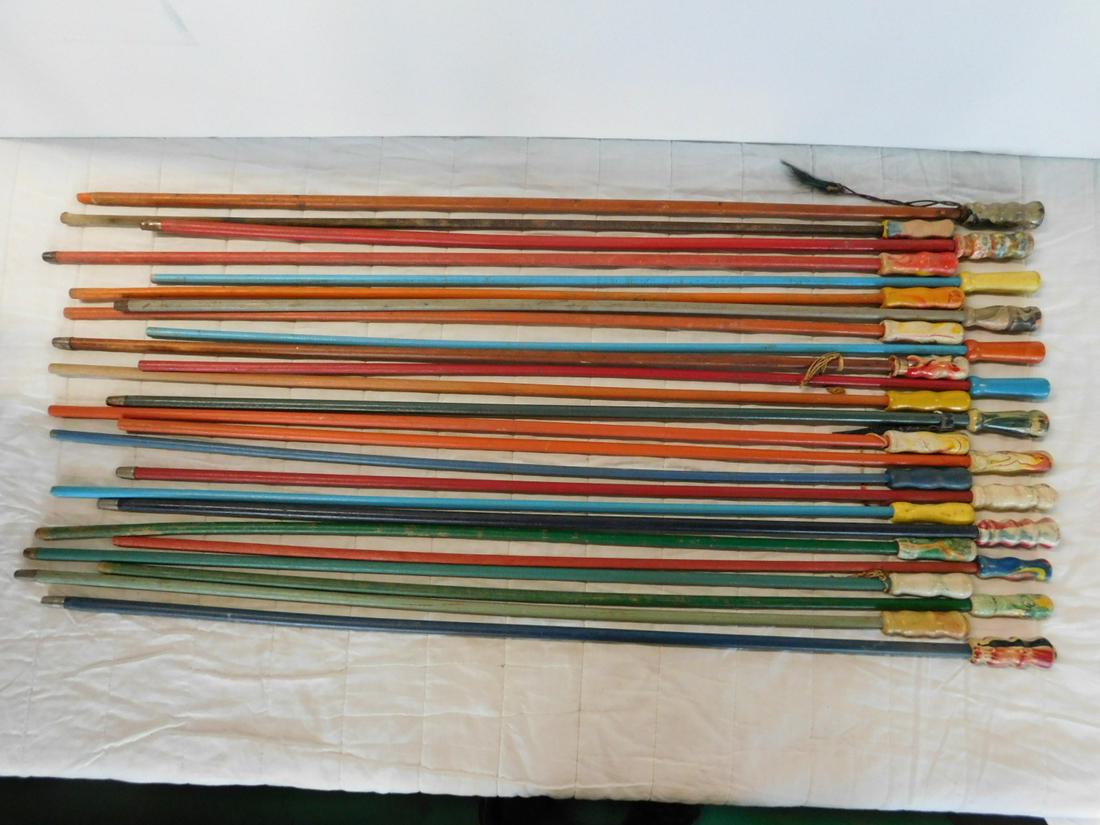 25 Wood Handled Carnival Canes: 25 Wood Handled Carnival Canes, all with painted wood heads ( some multi color), wood shafts and ten with ferrules on ends, 35" -39" long. CONDITION: Some cane heads have some to minor paint loss.