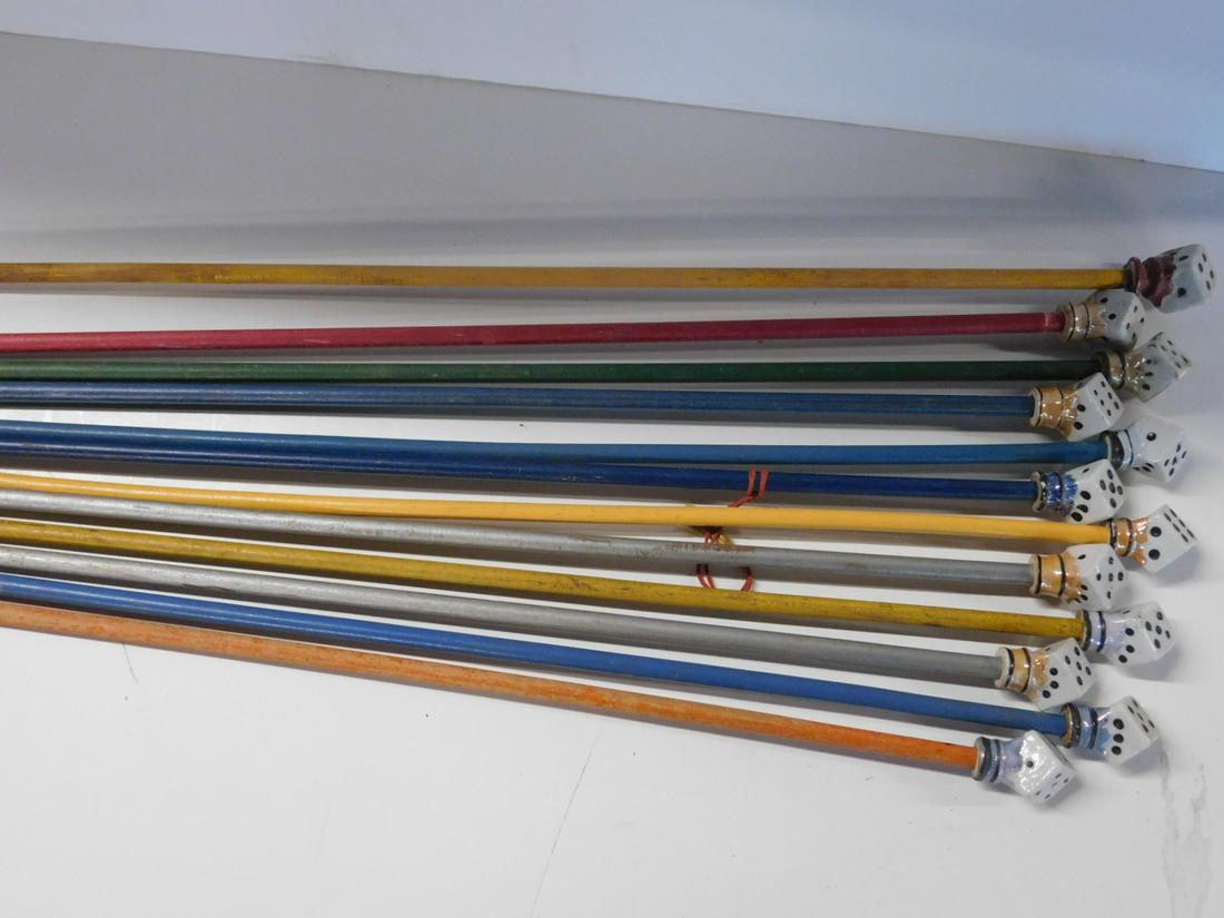 12 Porcelain Head "Dice" Carnival Canes: Twelve Porcelain Head "Dice" Carnival Canes, each with glossy hand painted die, cane head, 2 1/8" on painted wood shaft (six with ferrule tops), 33 1/2" - 35 1/2". CONDITION: Minor loss on porcelain c
