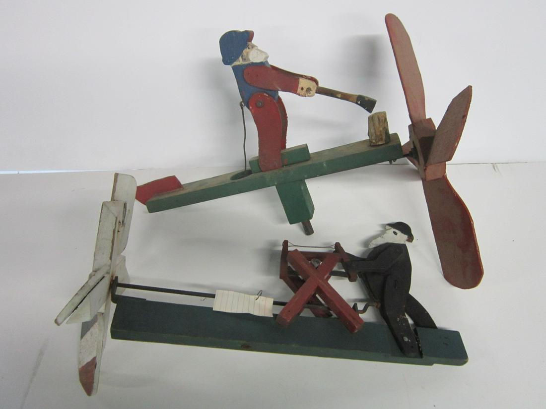 2 Vintage Log Sawing & Chipping Whirligigs: Two Vintage Log Sawing & Chipping Whirligigs including: one with bearded man sawing a log, four red white and blue 4" blades, 18"l, 9 1/4"h and one with bearded man chopping log,four red 6 1/2"blades,