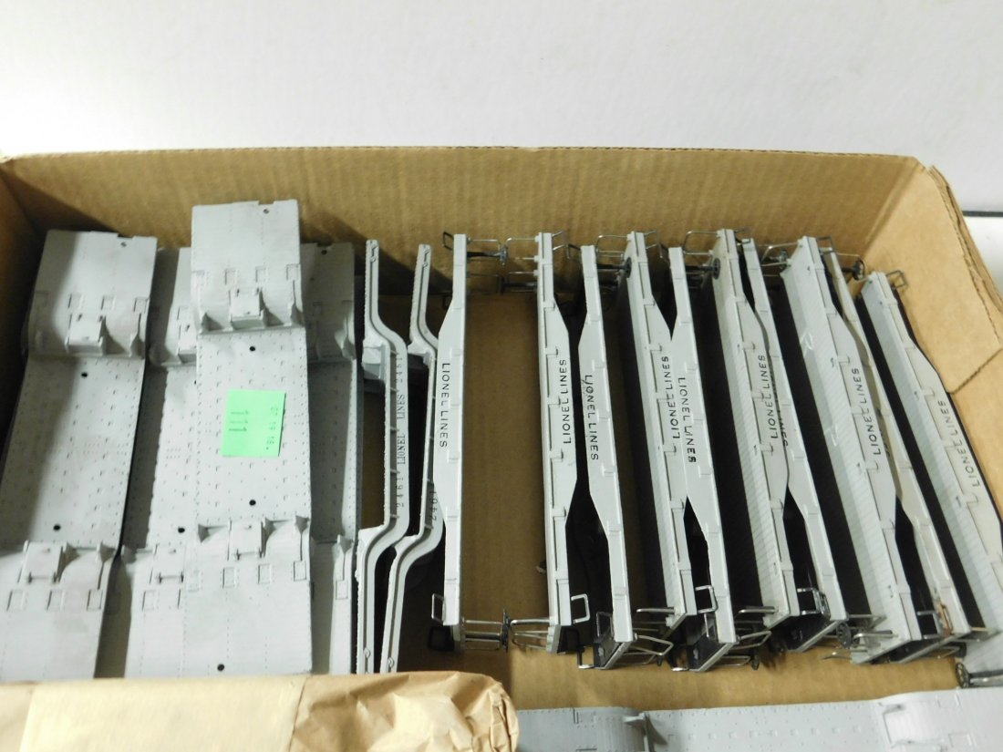28 Lionel Metal Gondola Cars Body Only!: 28 Lionel Metal Gondola Cars Body Only! All post war including: ten 2411 Flatcar, 8\" each and eighteen Lionel Lines depressed center transformer car, 9\". CONDITION: Some minor surface wear and very 