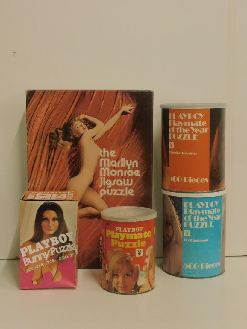 Vintage Playboy Jigsaw Puzzles: Five items, consisting of: two large Playboy Playmate can puzzles, one small Playmate can puzzle, a Playboy Bunny puzzle in a tall box and a 500 piece Marilyn Monroe nude puzzle. Condition; Some wear 