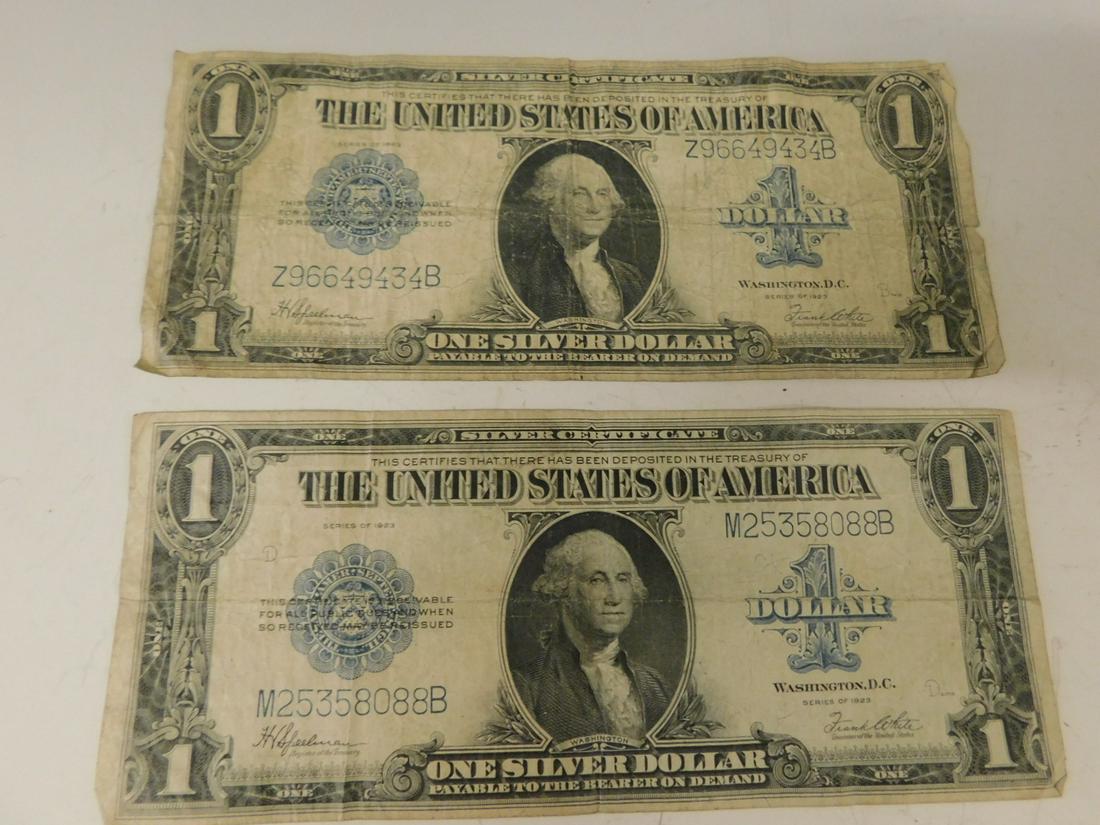 2 US 1923 Series $1 Silver Certificates: Two US 1923 Series $1 Silver Certificates, white and Speelman treasury marks. CONDITION: Folds, soiled, one with edge tear.