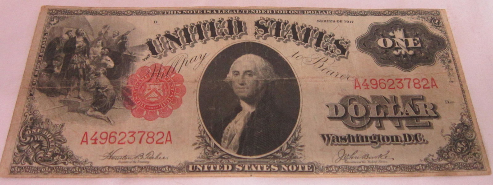 $1 Large Legal Tender Note: $1 Large Legal Tender Note, Washington in center, Columbus scene on left, series 1917 Jeff - Burke, horizontal fold and badly noticeable center fold, VF - 30. CONDITION: Grading obtained using Heritag