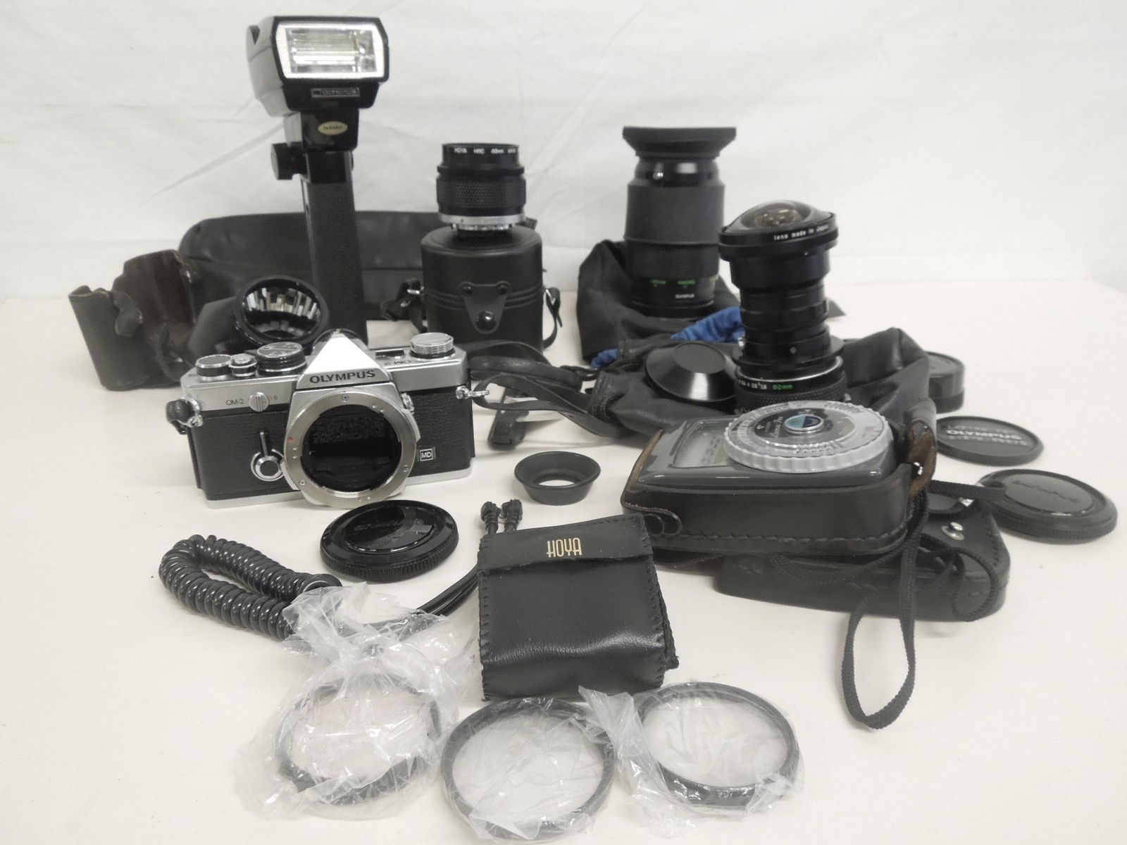 Olympus OM-2 Camera & Accessories: Olympus OM-2 Camera and Accessories, serial number 522906, includes: Spiratone Fish-eye lens 0.15X; Hoya 55mm Skylight (1B) lens; Vario - spiegel - Vorsatz; Hoya HMC 49mm UV ( 0 ) lens, assorted Hoya