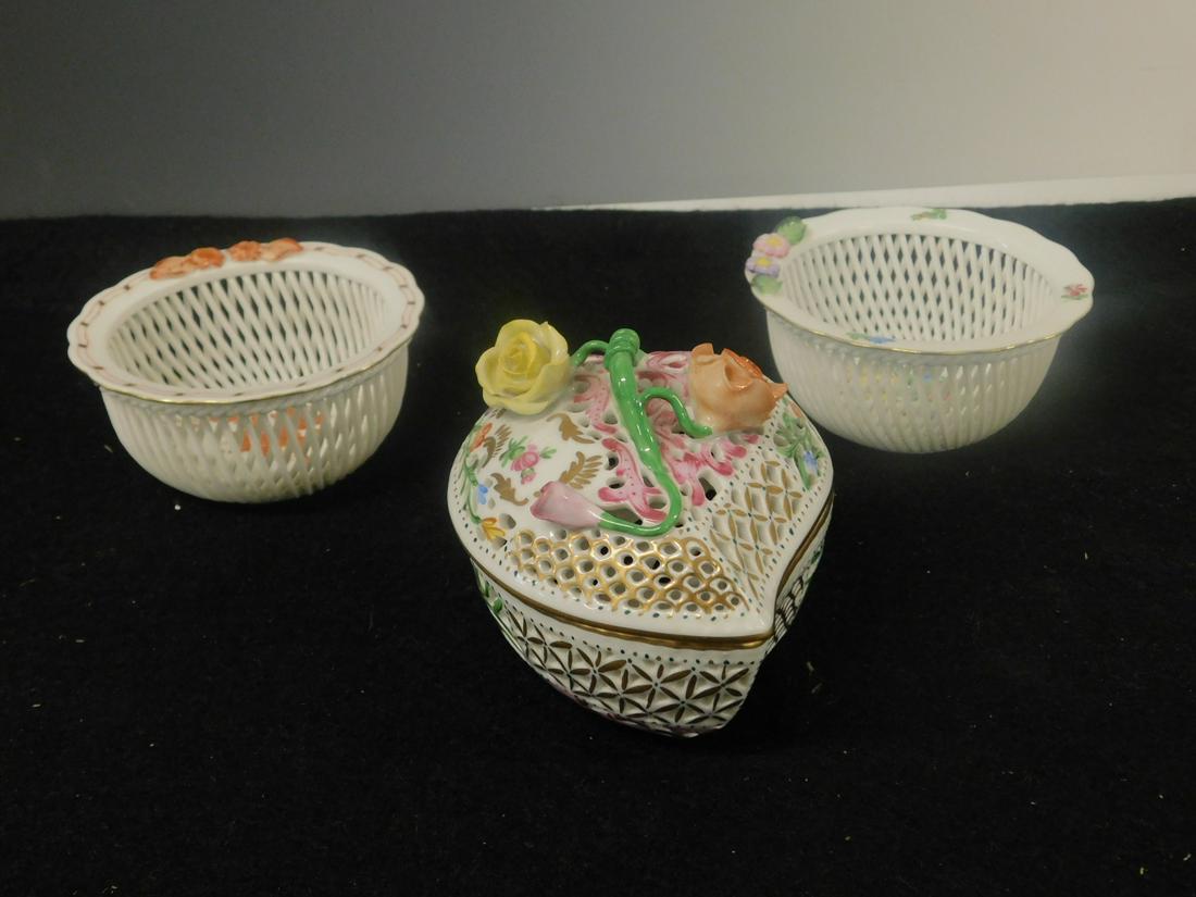 3 Herend Giftware Pieces: Three Herend Giftware Pieces includes: reticulated heart shape covered box with painted and applied flowers and two basket weave jars, with applied and painted flowers, 4"d, 2"h. CONDITION: Excellent.