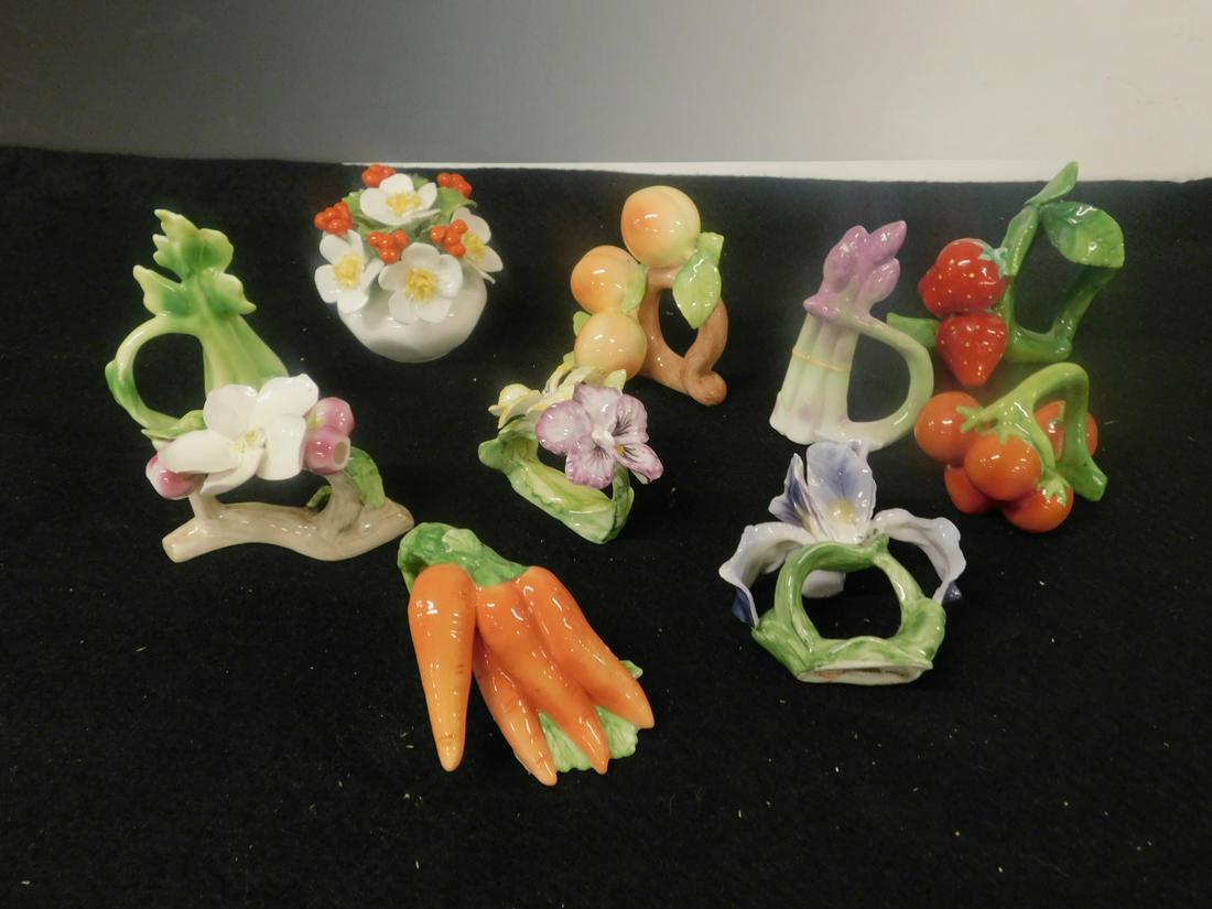 Porcelain Napkin Rings, etc: Porcelain Napkin Rings, etc includes: nine fruit and floral sculptured bone china (Philippines) napkin rings and Aynsley floral and berry piece, late 20th C. CONDITION: Very good, one flower chipped o