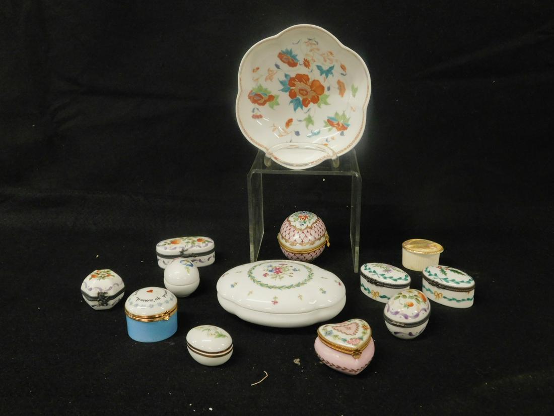 13 Limoges Trinket Boxes, Etc.: Thirteen Limoges Trinket Boxes, Etc. includes: nine hand painted porcelain hinged trinket boxes with floral decorations in various shapes and sizes; two Limoges egg form, one Ansley with transfer bird