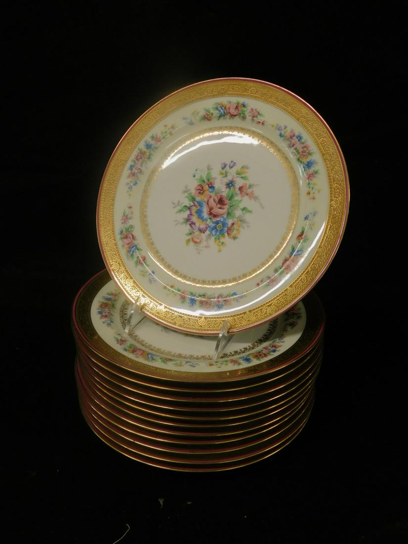 12 Limoges Porcelain Service Plates: Twelve Limoges Porcelain Service Plates, Charles Ahrenfeldt, floral bouquet painted centers, gilt floral spray edge within a gilt pink rim, 10 1/4" d, early 20th C. [121] CONDITION: Excellent, no issu