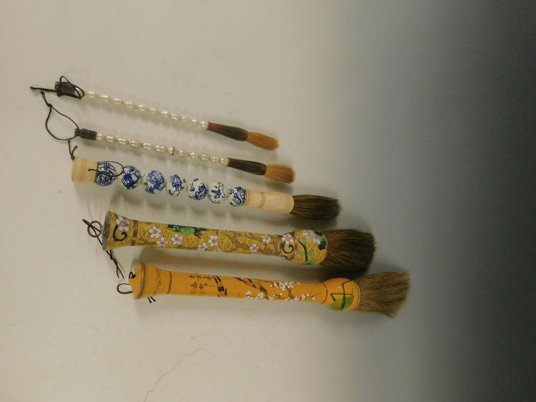 5 Chinese Calligraphy Brushes: Five Chinese Calligraphy Brushes includes: 14" yellow cloisonne with flowers and birds; a 15 1/2" peach enameled - signed with insects, flowers and birds; a 12 1/2" blue and white porcelain Dragon bea