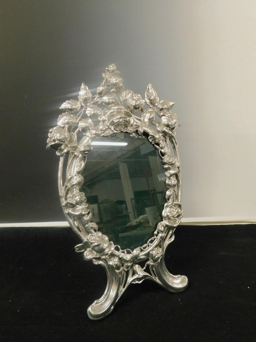 Rococo Pewter Picture Frame: Rococo Pewter Picture Frame by Elias, USA, model 1698, "Contains Silver", free standing, open work castings with flowers and vines, late 20th C, 17 1/2"h, 10 1/2"w. CONDITION: Very fine.