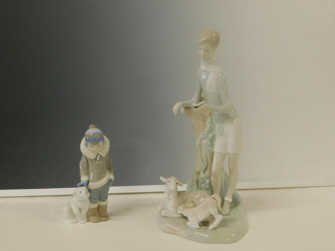 2 Lladro Figures: Two Lladro Figures includes: 11" standing man with tree stump with two lambs at his feet, and a 5 3/4" Eskimo boy with baby polar bear. CONDITION: Very fine, no issues identified.