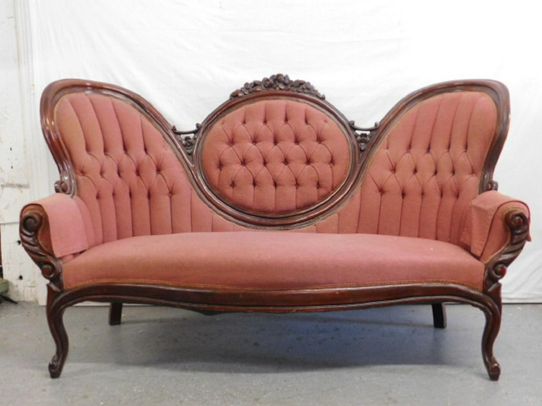 Victorian Rococo Revival Settee: Victorian Rococo Revival Settee, mahogany, triple arched tufted back with rose carvings, serpentine seat, cabriole front legs, rose cloth upholstery, 68"l, 41"h. CONDITION: Very good, mild usage.