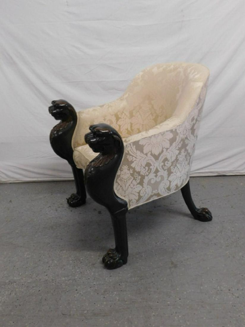 Egyptian Revival Arm Chair: Egyptian Revival Arm Chair, two tone hardwood lion half torso curved arm supports terminating to claw feet which are repeated on the splayed back legs; pale yellow silk floral pattern upholstery, 20th