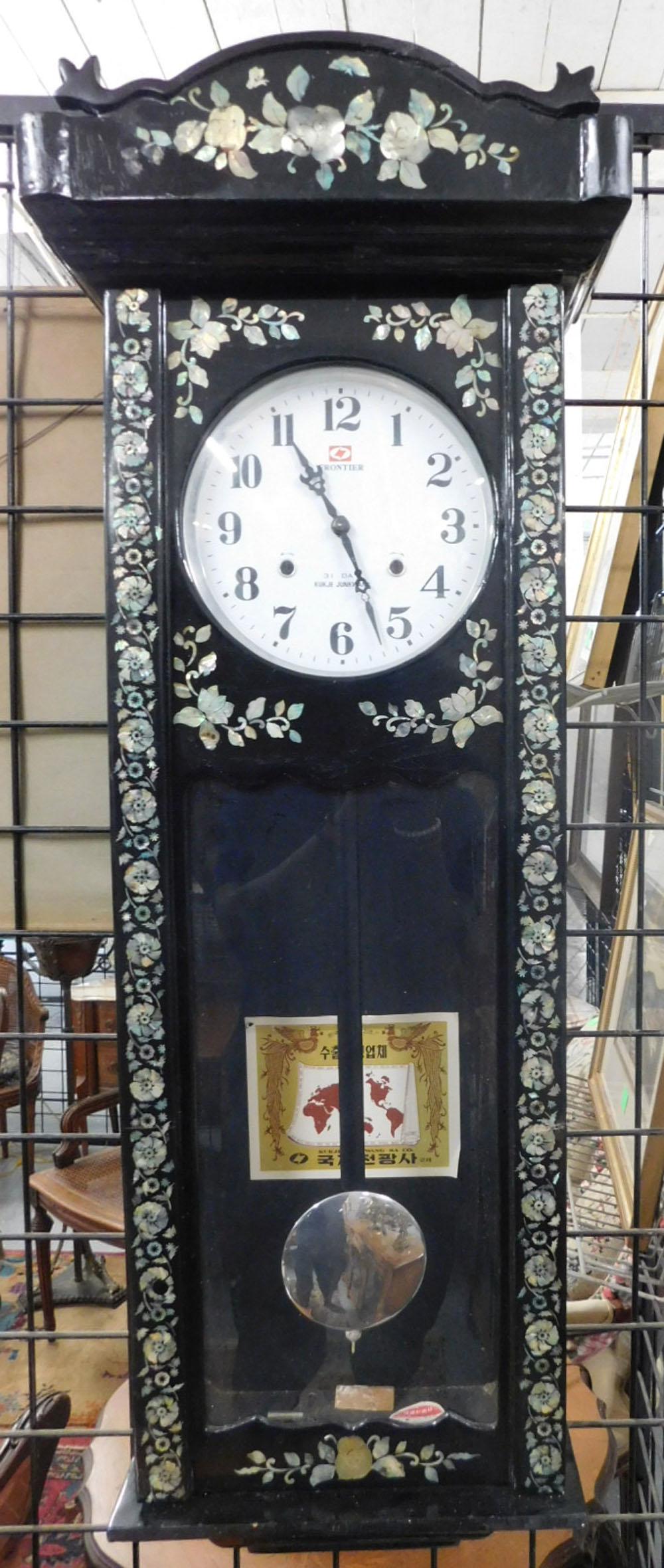 Unique Oriental Wall Clock: Frontier Kukje Junkwang Wall Clock 31 day key wind, pendulum drive movement,glossy black lacquer with mother of pearl floral inlays, late 20th c. 45" x 13" x 7". working condition w/key, minor scratch