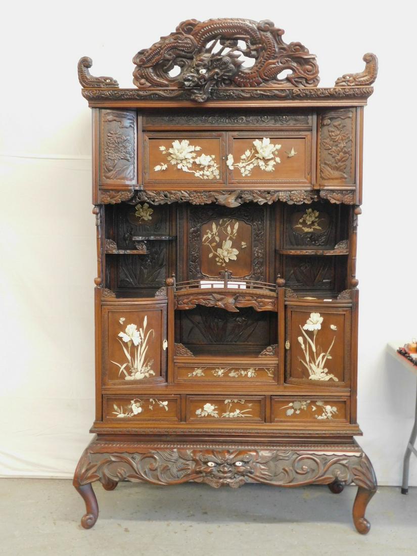 Antique Chinese Carved Etergiere: Antique Chinese Etergiere, cherry mahogany finish and teakwood; in two parts; elaborate carved and pierced dragon and dolphin crest over a shaped front featuring floral and bird carved panels and pend