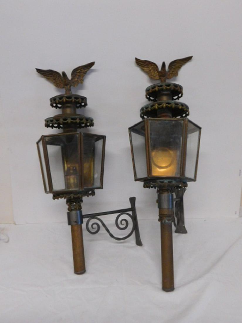 Pr Brass Wall Lanterns: Pr Brass Wall Lanterns, tapered Hexigon form with cast drapings and spread wing eagle crests, wrought metal wall brackets, not electrified, approx 27"h, mid 20th C. CONDITION: Tarnished, few metal din