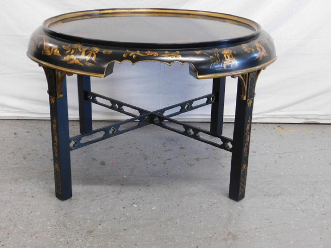 Chinese Chinoiserie Coffee Table: Chinese Chinoiserie Coffee Table, black lacquered will gilt painted scenes and shrubery, rounded and shaped apron, four square legs with open work stretches, 20th C, 34"d, 23"h. CONDITION: Very good c