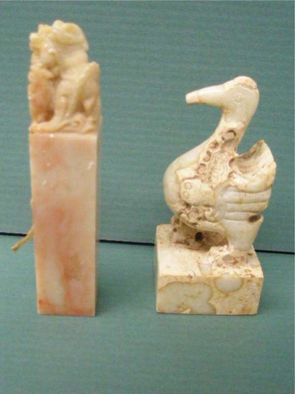Two Chinese Stone Seal Carvings: Two Chinese stone seal carvings, 1) Yellow russet soapstone with sculptured dragon crest, 4 1/4", 2) Cream colored stone with sculptured Duck crest, (tip of beak missing)