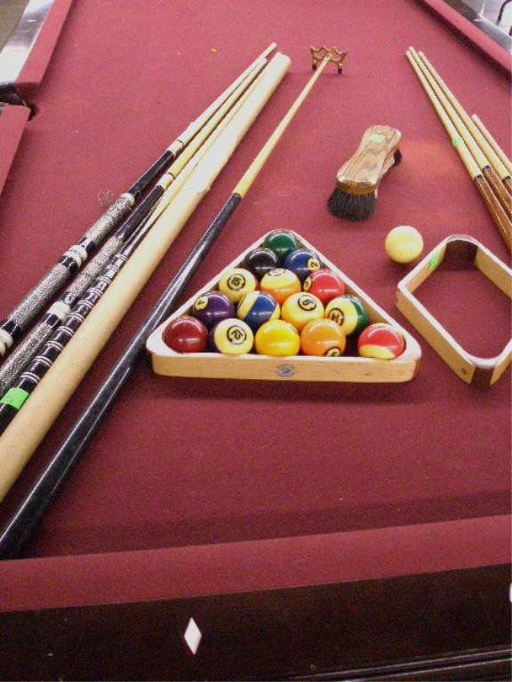 Brunswick pool table: Brunswick pool table, 4' x 8', mahogany, leather individual pockets, three-slate top; standard and nine-ball rack, cue and 15 balls; 6 cue sticks, child's and bridge