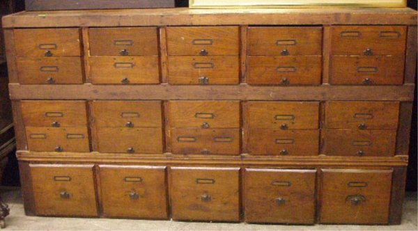 25 Drawer File Cabinet: 25 drawer file cabinet, walnut drawer fronts hand made pine frame, iron drawer pulls, late 19th C::: Dimensions: 68"=l; 10"=w; 37 7/8"=h ; drawers: 12 x 10 1/2 x 4 1/2 AND 12 x 10 x 10