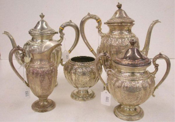 Frank M. Whiting & Co. Sterling Tea Set: Frank M. Whiting & Co. sterling silver five piece tea set w/hand chaised & embossed floral design, 11" coffee pot, 10" tea pot, 7" creamer, 7 1/2" covered sugar & 4 1/2" waste bowl, 76.11 oz