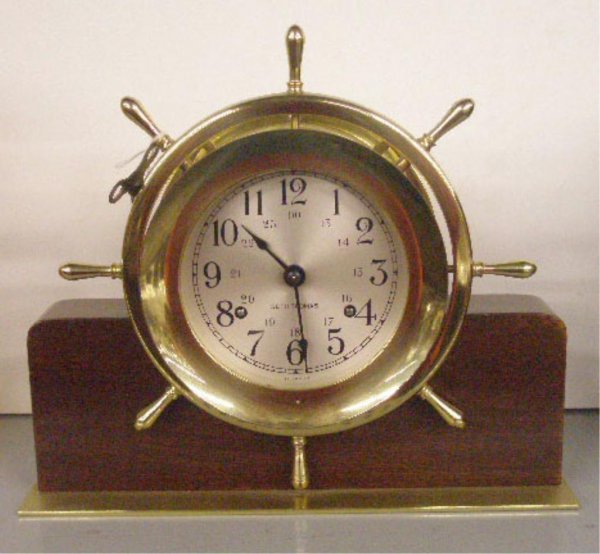 Seth Thomas Brass Ship's Clock: Seth Thomas brass cased 8 1/2" ship's clock set in mahogany & brass base, German time & strike movement