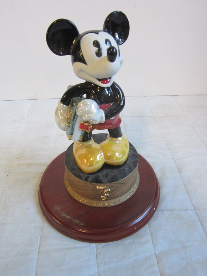 Mickey Mouse Collectible Figurine: Mickey Mouse Collectible Figurine, 75 Years of Love & Laughter, porcelain figurine on artist signed wood base, pie Â– eyed Mickey holding books with brass Disney coin under base, limited edition 1,