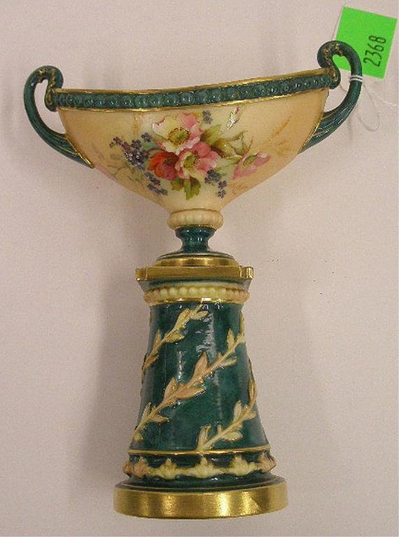 Royal Worcester Porcelain Urn: Royal Worcester porcelain double handle 7 1/4" urn on base, hand painted and raised work floral decoration