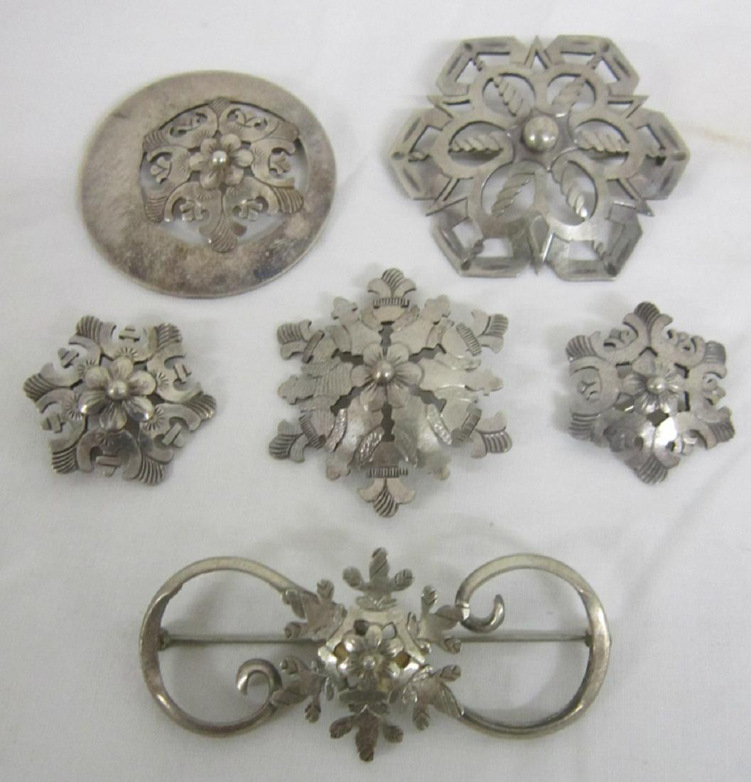 6 Sterling Pins: Six Sterling Pins, rosette and scroll open work designs; includes: a five piece set and a single pin, from 1" to 2 1/2", approx. 1.75 ozts TW.[14] CONDITION: Very good, used cond.