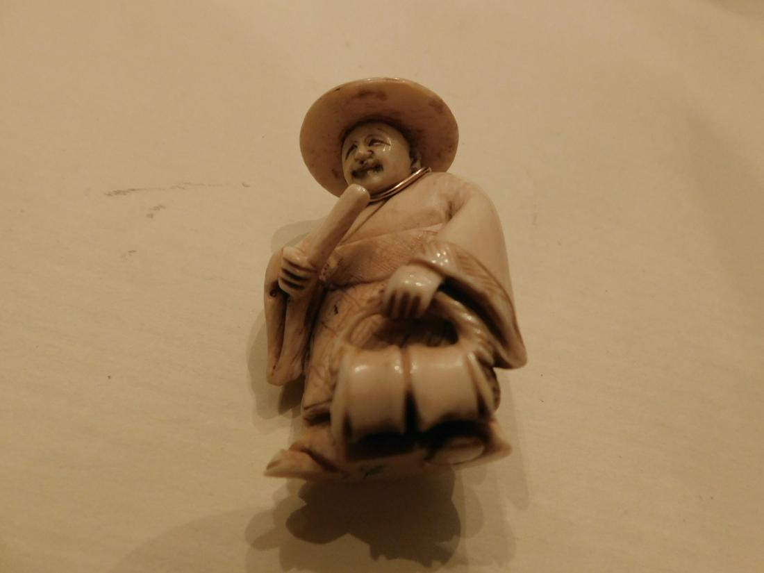 Chinese Carved Netsuke: Chinese Carved Netsuke, depicts a standing man with straw hat, scroll and satchel, signed on base, fitted with a 14k yellow gold (tested) wire form mount, used as a pendant, early 20th C. 2"h.[10] CON