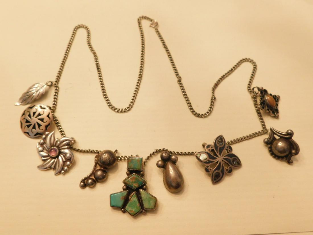 Sterling Charm Necklace: Sterling Charm Necklace,26" round link chain holds ten different sterling charms, primarily Mexican, two artist signed; includes: turquoise, abalone, etc. enhanced charms, 20th C. CONDITION: Very good