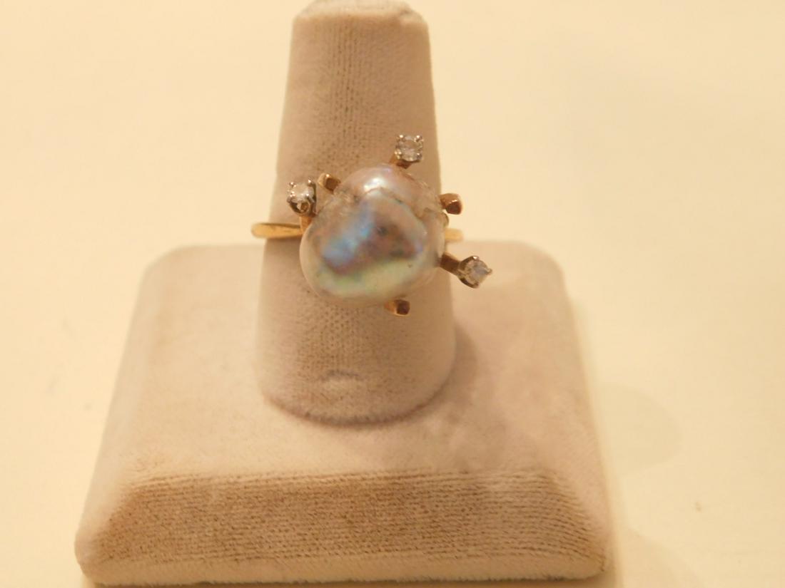Tested 10k WG Ring w/Blue Baroque Pearl: Tested 10k wg ring with blue baroque pearl, free form 13 x 11 mm with 3 tall prong set diamond chips; 6 total prongs support the pearl. CONDITION: Good, Pearl has a hairline crack from one side and ac