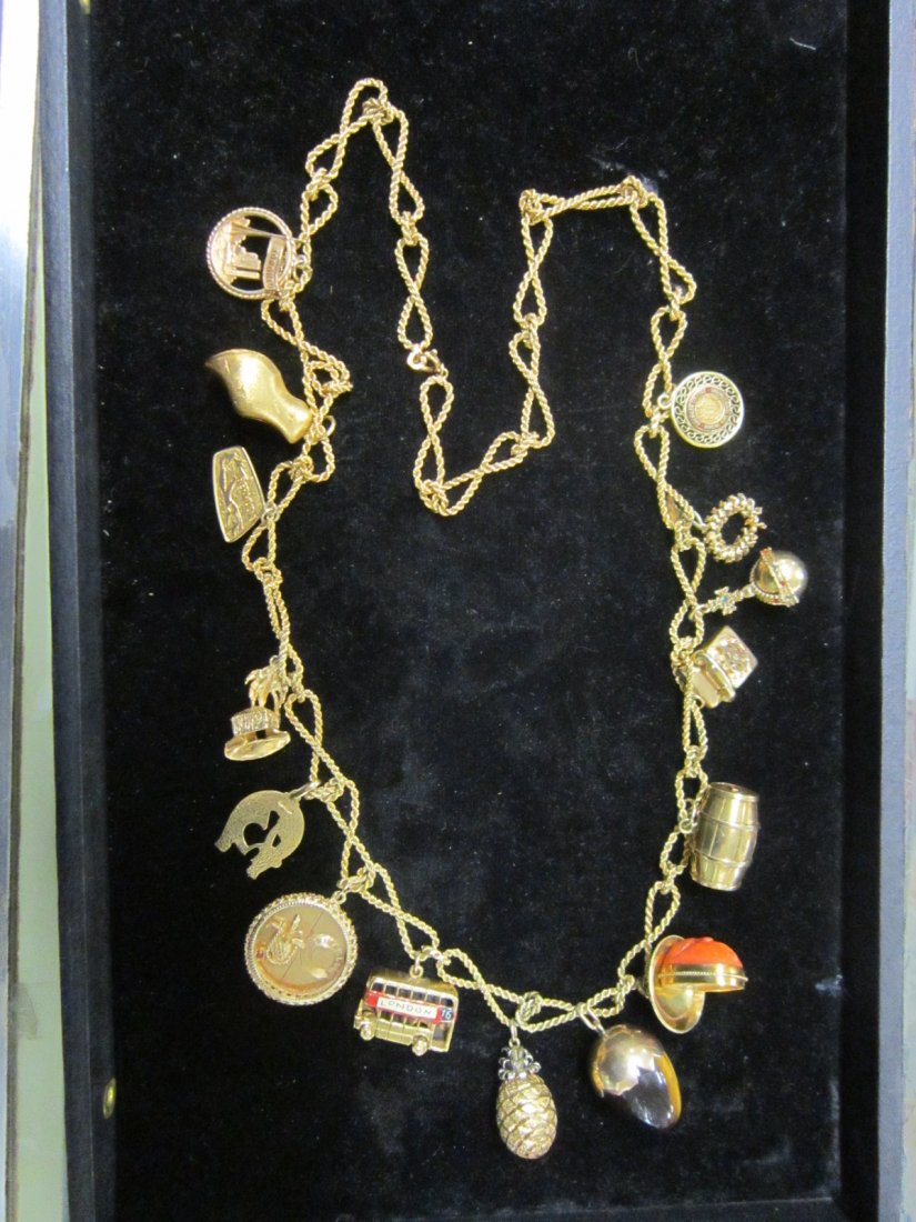 18k YG 30" Charm Necklace: 18k YG 30" Charm Necklace, 18K twisted rope infinity links with 14k and 18k charms, double decker bus is 9ct. Only one gold filled nurses charm. 60+ DWT not weighing tiger eye and coral charms.[12] CO