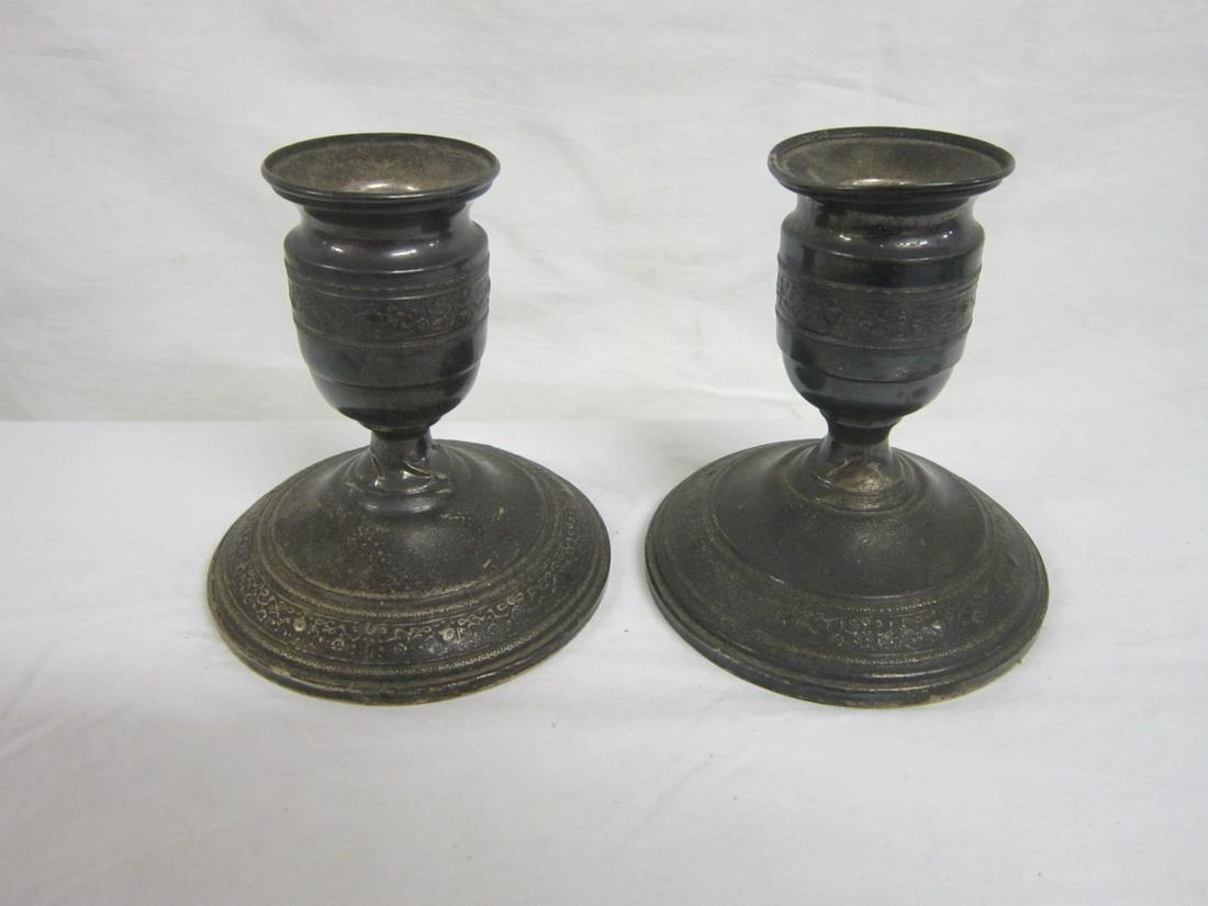 Pr Sterling Silver Candlesticks: Pair Sterling Silver Candlesticks, possibly by M.F. Hamilton & Son - Phila 1904-1909, (MHF); floral scroll and urn repousse borders, weighted, 4 3/4"h, base 4 1/2"d. CONDITION: Tarnished, twisted meta