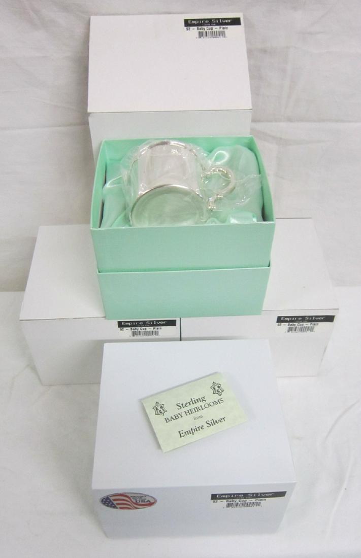 4 Empire Sterling Silver Baby Cups: Four Empire Sterling Silver Baby Cups, plain design with acanthus scroll handles, model 92, all new in original fitted boxes, boxes 5 1/2" X 5" X 4". CONDITION: New.