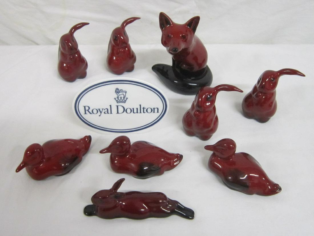 10 Royal Doulton Flambe Animals: Ten Royal Doulton Flambe Animals includes: seated fox, style 2, 4 1/2"; four lop eared hares, 2 3/4", three ducks, 3 1/2"; and one reclining rabbit; includes: Royal Doulton porcelain plaque. CONDITION
