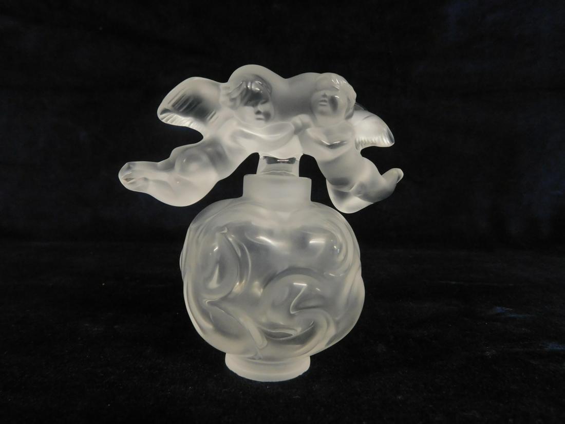Lalique Nuages Perfume Bottle: Lalique Nuages Perfume Bottle, No. 1132600, frosted crystal; twin cherub stopper, 4"h. CONDITION: New in box with original papers.