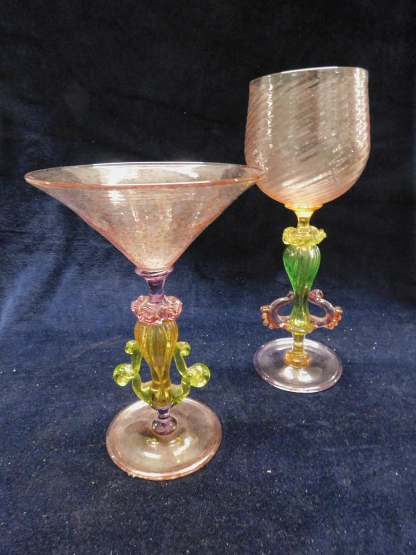 2 Venetian Glass Goblets: Two Venetian Glass Goblets, hand blown multi colored glass each with baluster form and applied scroll columns; illegible signatures engraved on bases with dates 1997, 9 3/4"h and 7 1/2". CONDITION: Ve