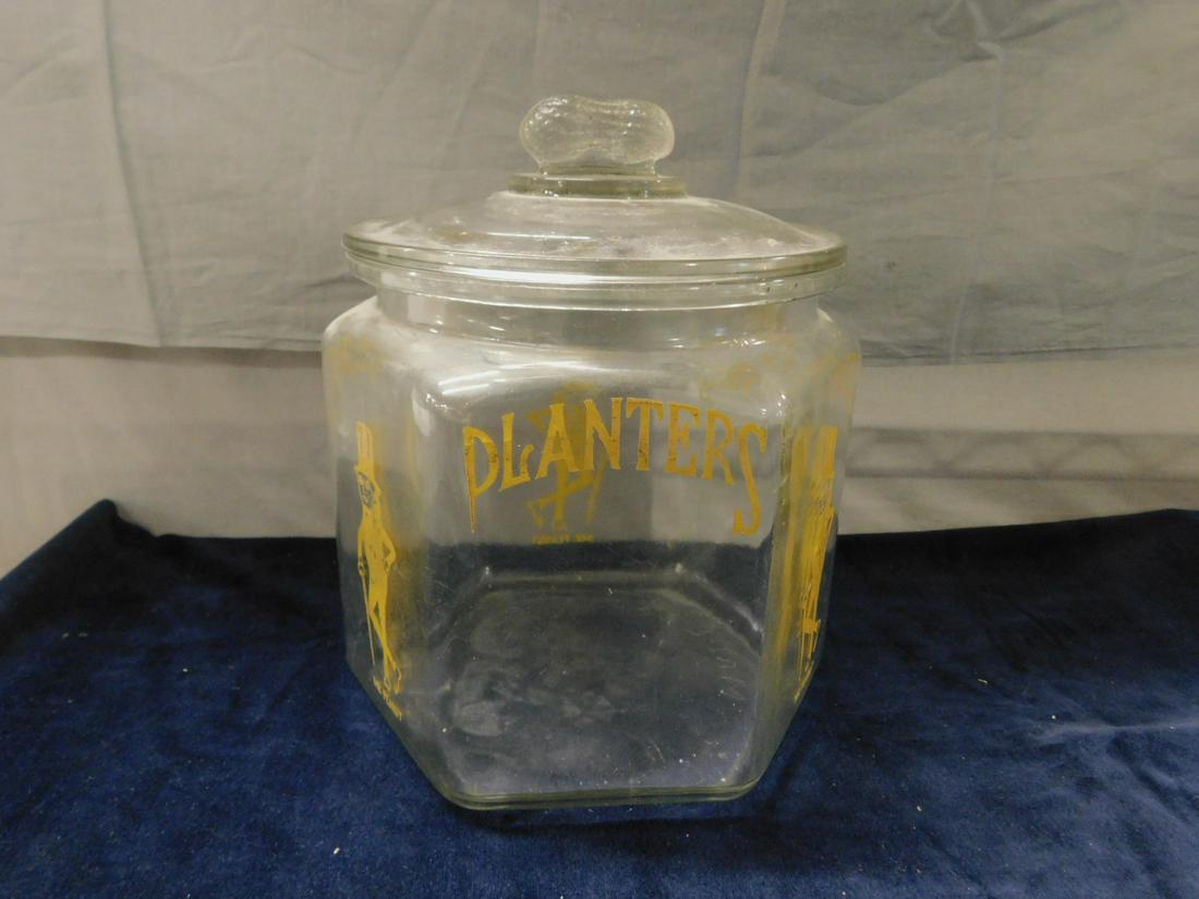Planters Mr. Peanut Jar: Planters Mr. Peanut hexagon Jar with peanut on lid - 1930s dispensing jar - large Mr. Peanut jar with yellow detailing, made in USA on jar. CONDITION: Chip on lid.