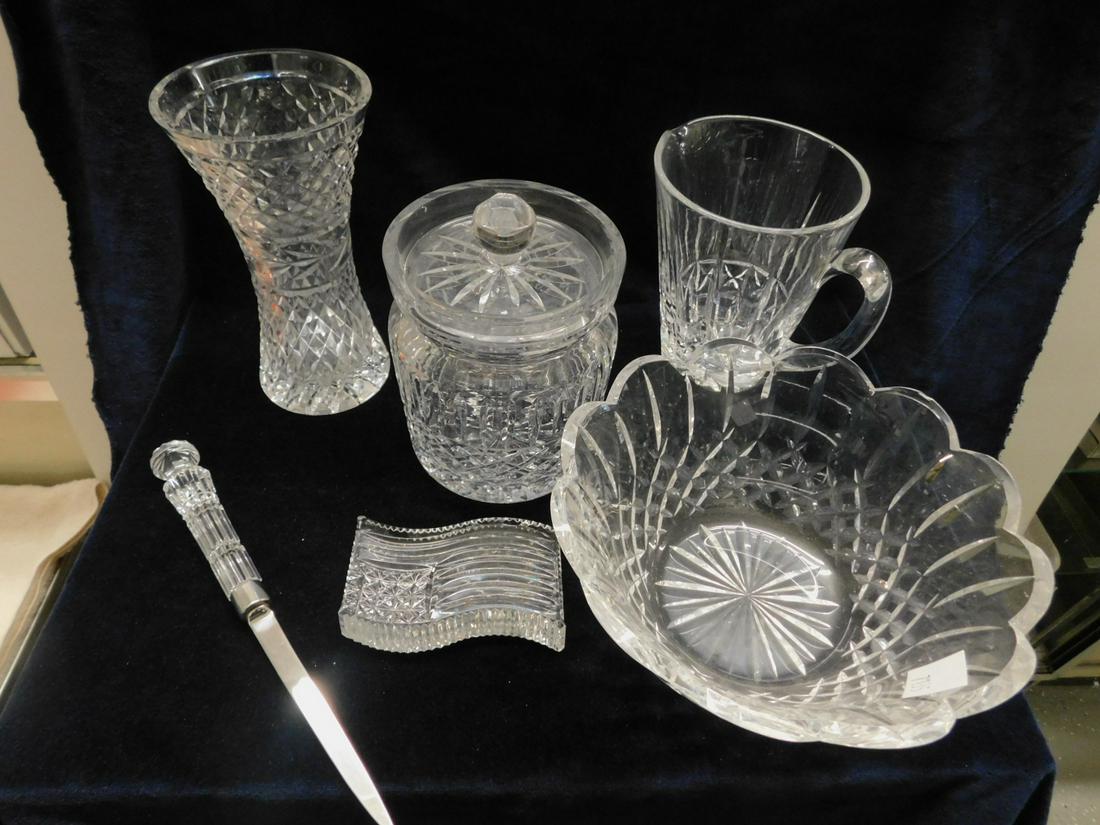 6 Pieces Waterford Crystal: Six Pieces Waterford Crystal includes: 8" vase, 6 1/4" pitcher,7" covered biscuit jar, 9"d x 4" h bowl, flag paperweight and a letter opener, 20th c. CONDITION: Very fine.